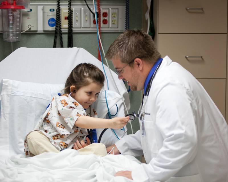Physician assistant with young patient.