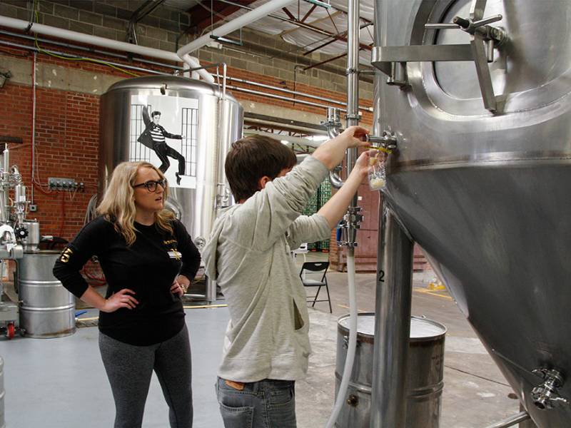 Biology interns working at a local brewery.