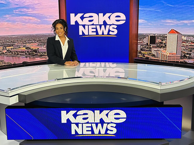 Student seated at the news desk of Wichita's ABC affiliate station.