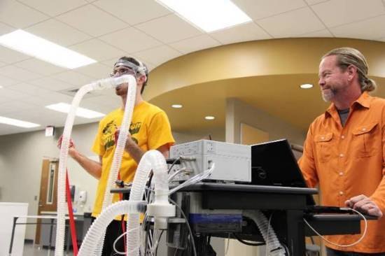 Dr. Rogers and student testing equipment