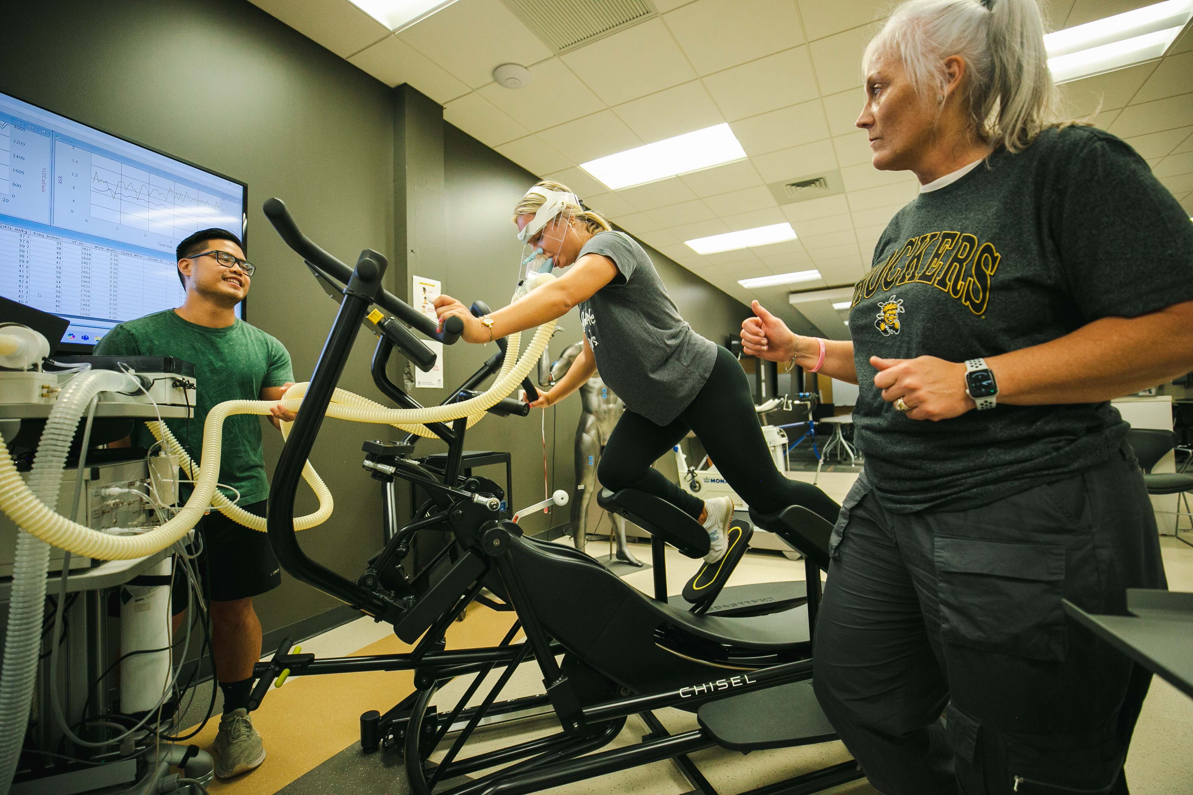 Exercise Science Students and Dr. Heidi Bell work with technology and equipmnet