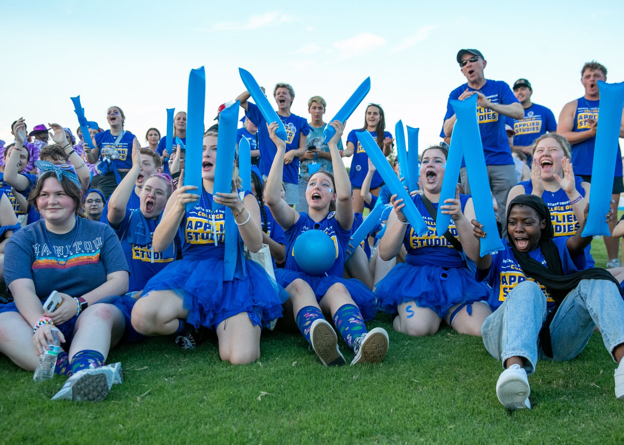 Clash of the Colleges - CAS group photo of students cheering on the field 