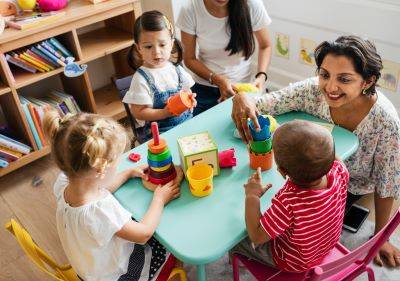Daycare teacher and children