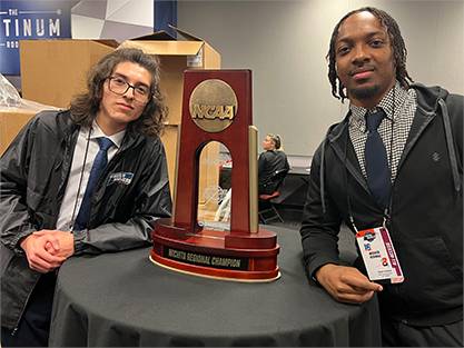 Students with NCAA regional trophy