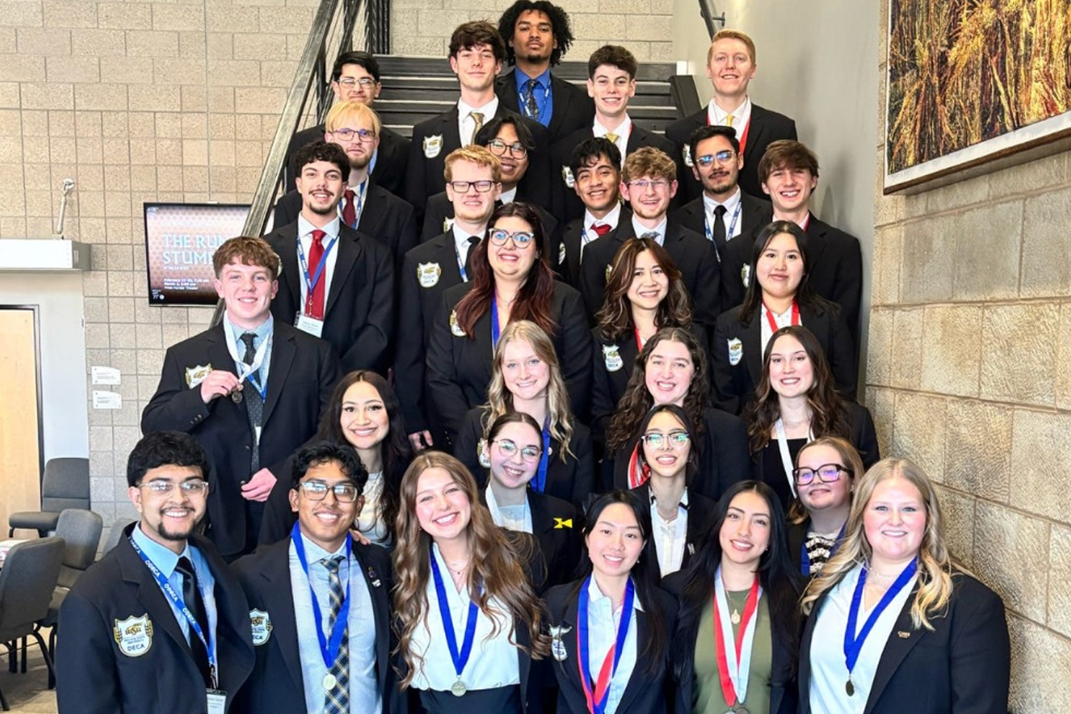 Deca students pose with their medals after a competition.