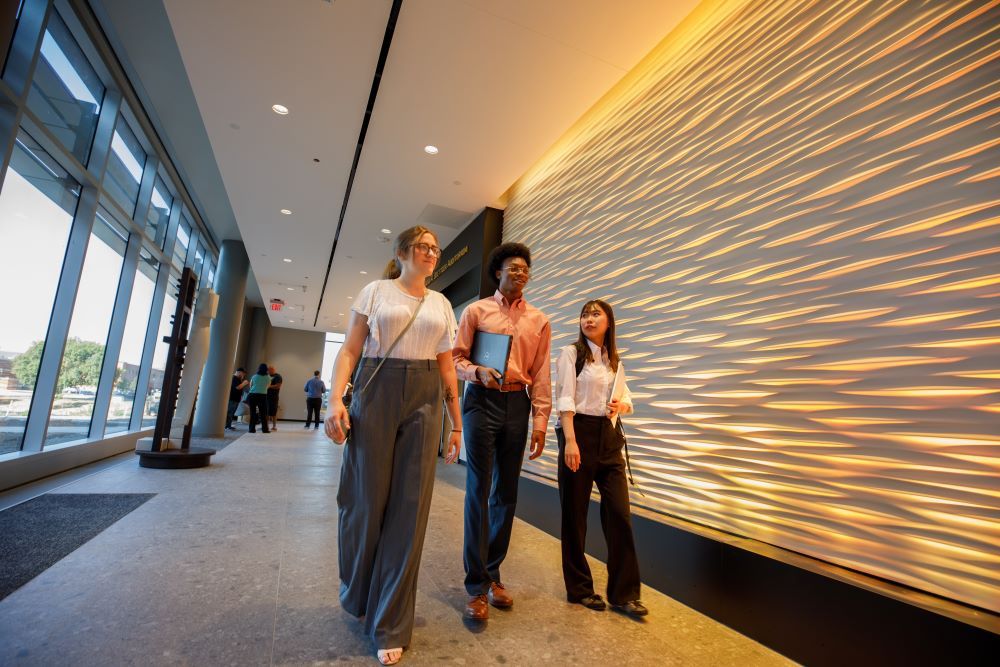 Students walking by WO Auditrium Wall