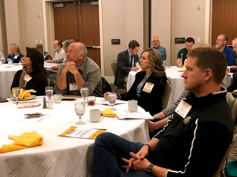 People sitting at a table listening attentively