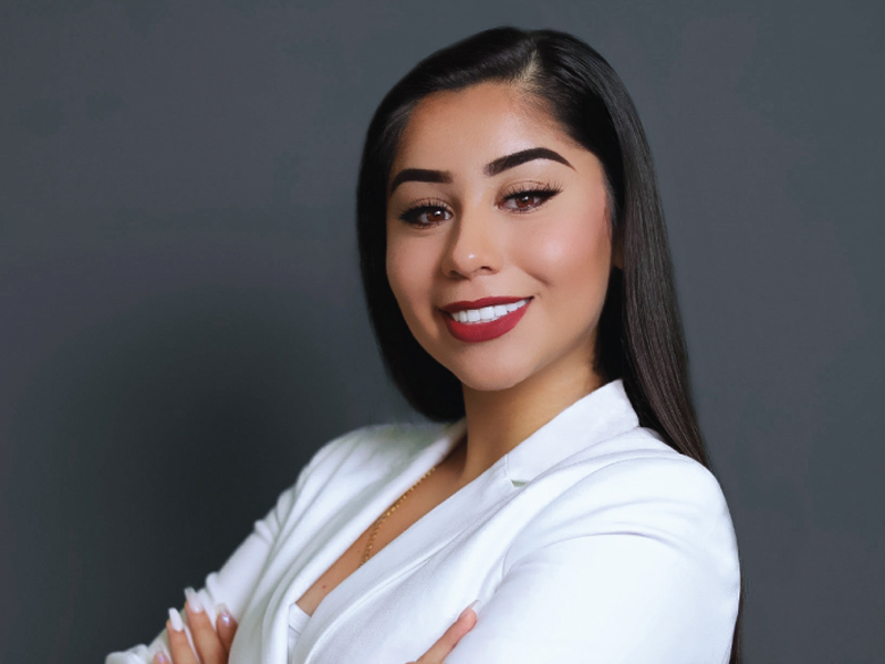 Michele Valadez in front of a grey back ground