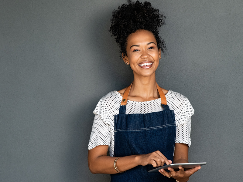 African American waitress holding a tablet ready to take an order..