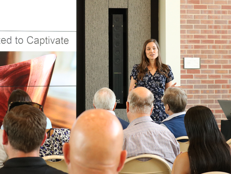 A woman presenting to a group. 