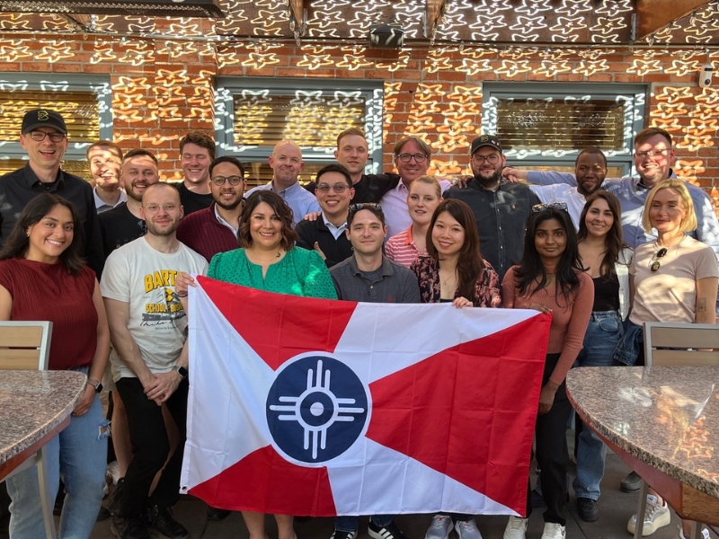 Berlin and WSU students holding the wichita flag in a group photo