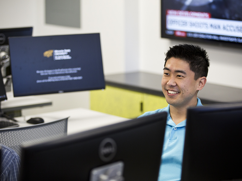 Smiling student sitting in a computer lab