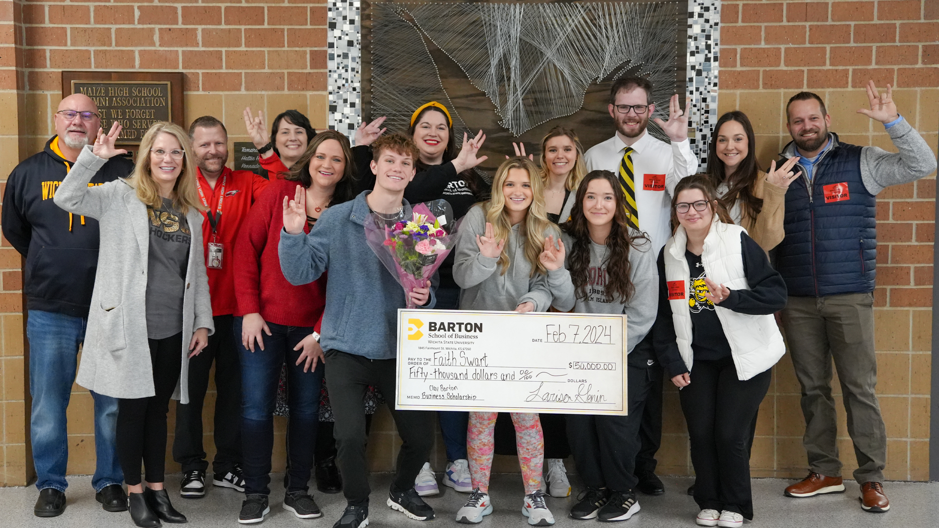 Faith Swart, the latest recipient of the Clay Barton Business Scholarship, poses with friends, family, Maize High School staff, and a contingent from the Barton School of Business and Wichita State University.