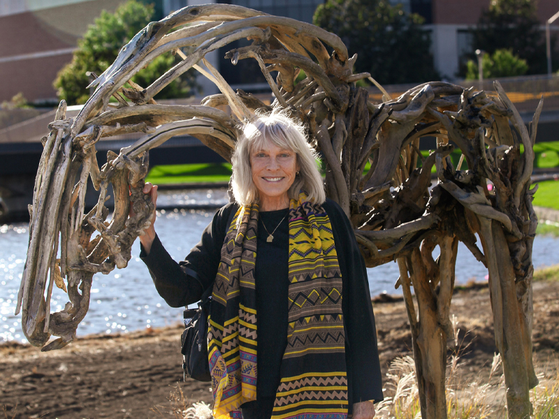 Sculpture artist Deborah Butterfield poses with Lumen outside Woolsey Hall