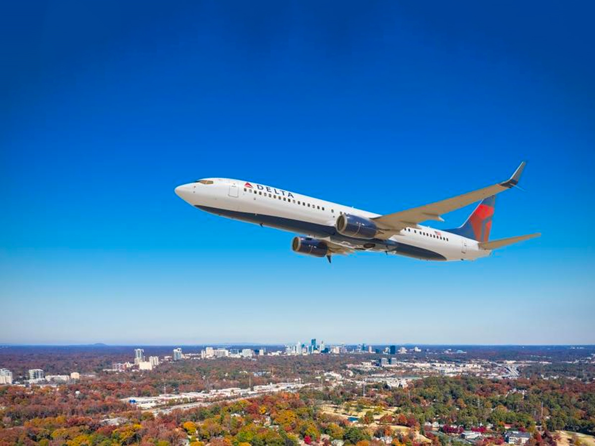Delta Airliner over a city.