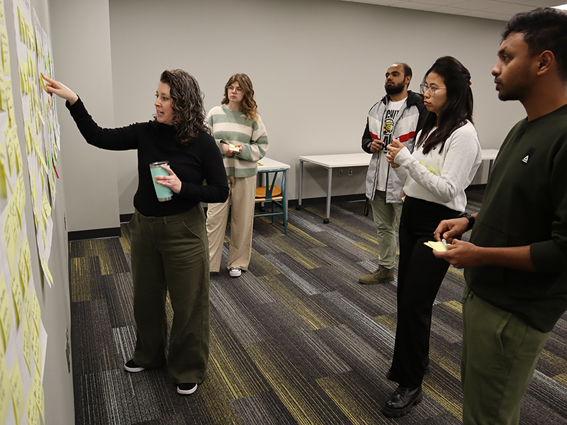 Faculty Member Maggie Schoonover leads a project discussion