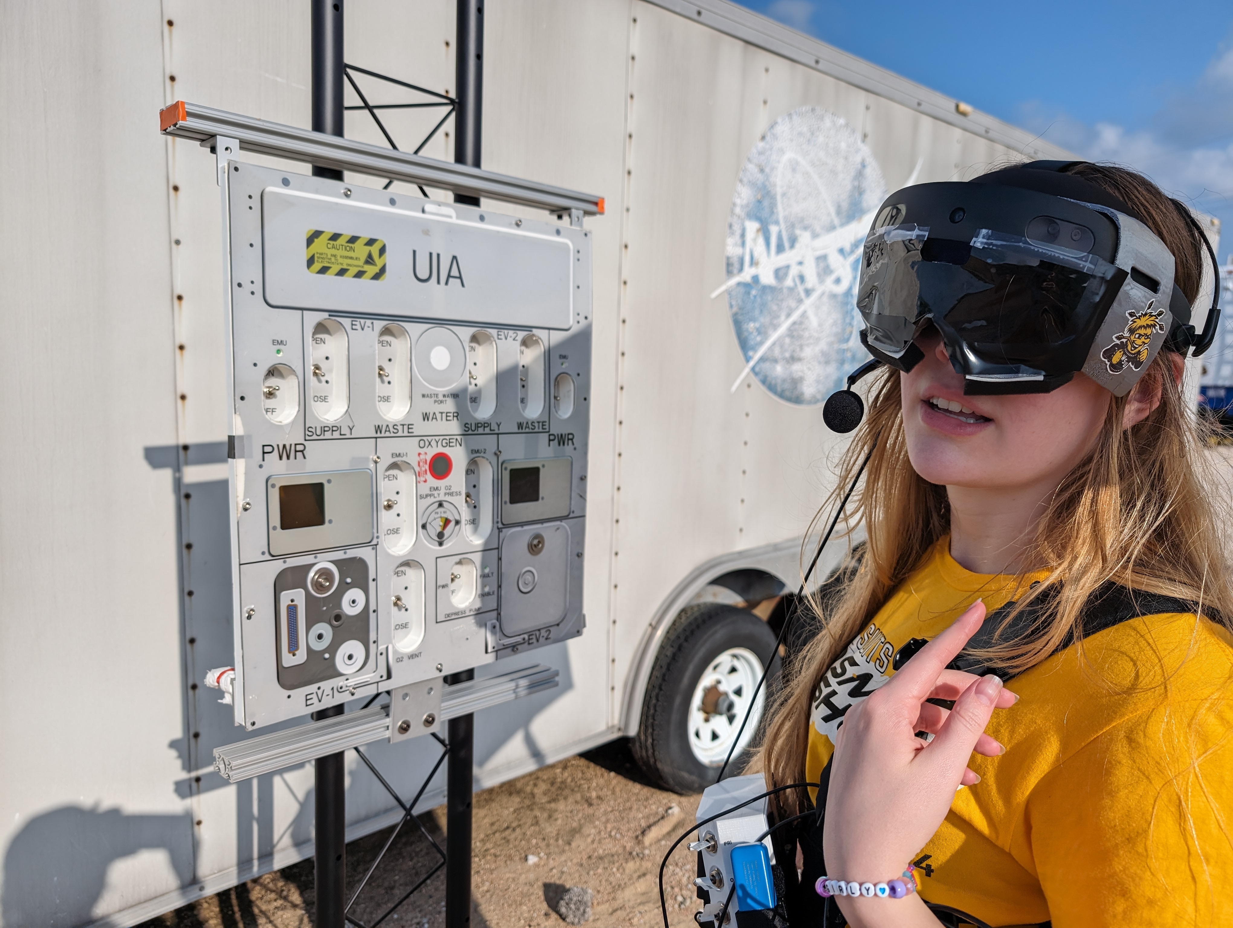 A student wearing an AR headset looking at the camera