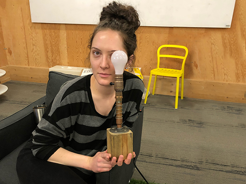 Kiley Burris holding lamp she designed and prototyped