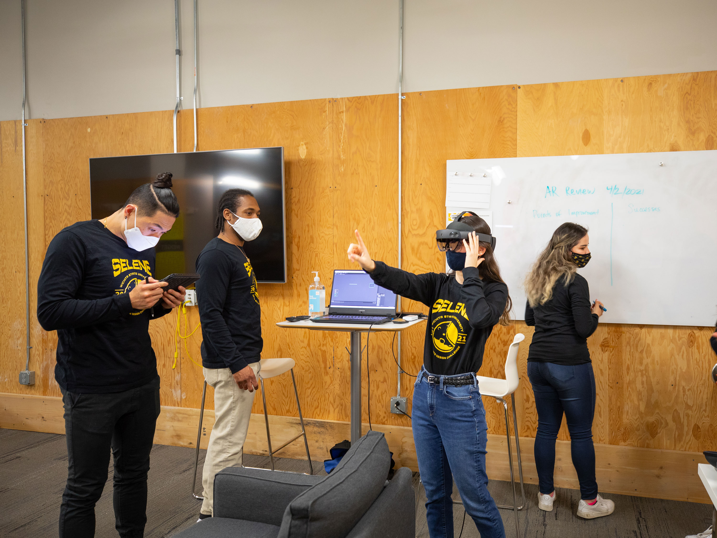 Photo of a team working with a virtual reality simulation. 