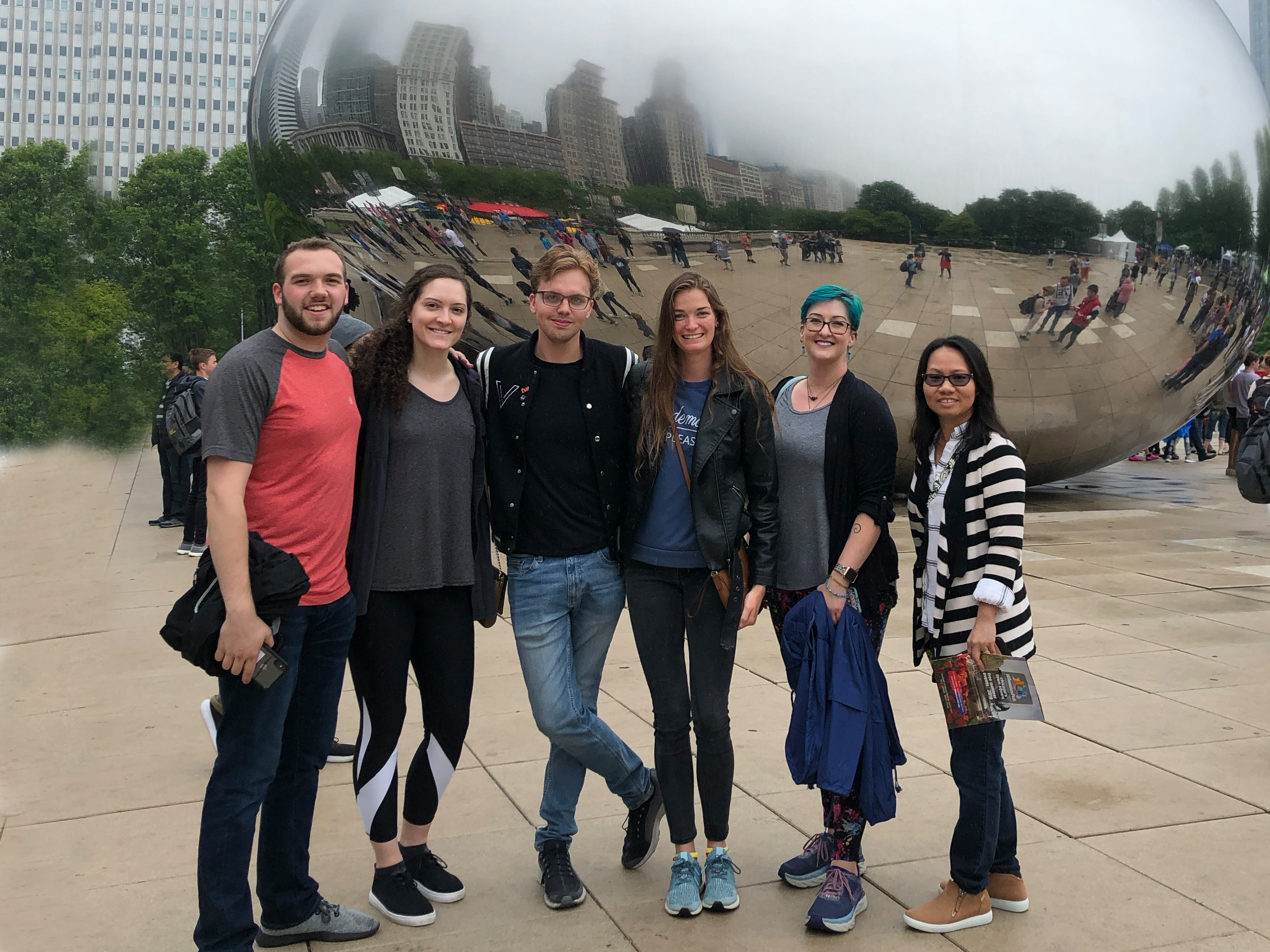 Six students pose for a photo in front of The Bean sculpture in Chicago.