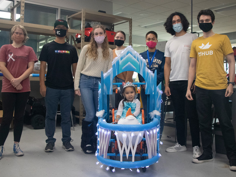 Student group with homemade costume for child in wheelchair
