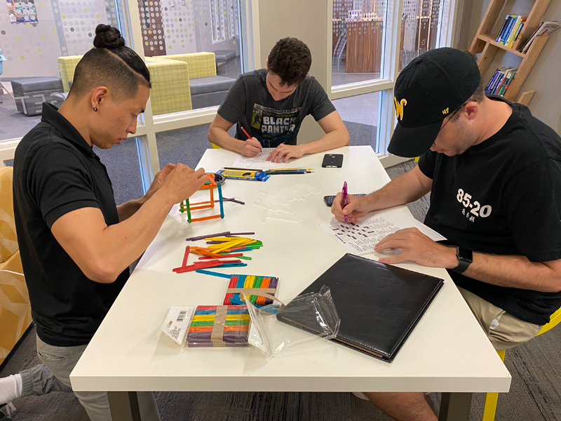 Arnold Kim working with a team in the ID 506 course