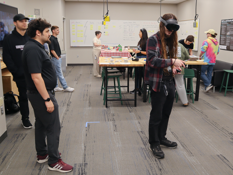 Braeden McKeown demonstrating VR Game in the Open XR Lab