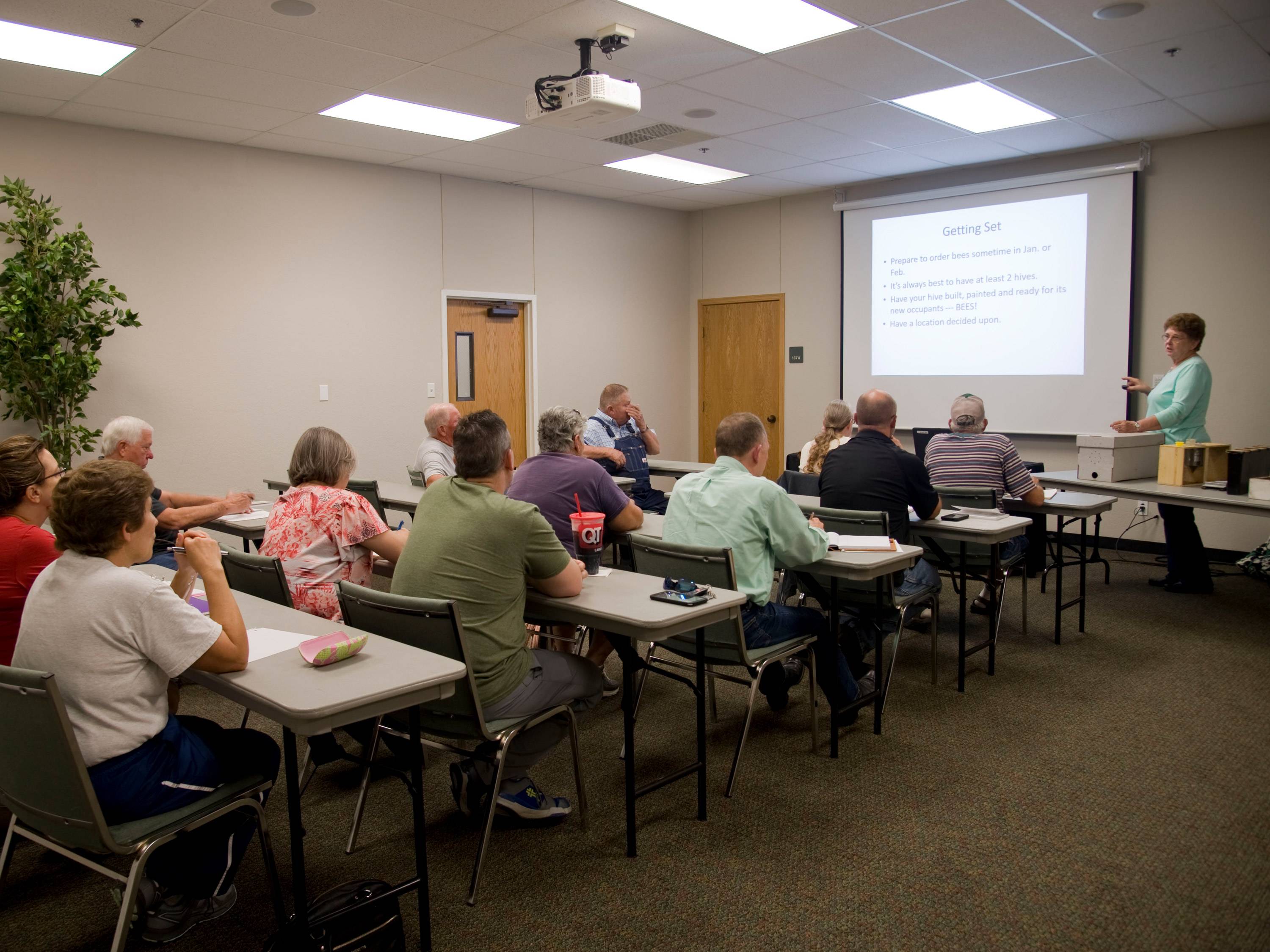 Adult students listening to lecture in classroom