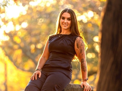 Bella Neish reclining on a rock.