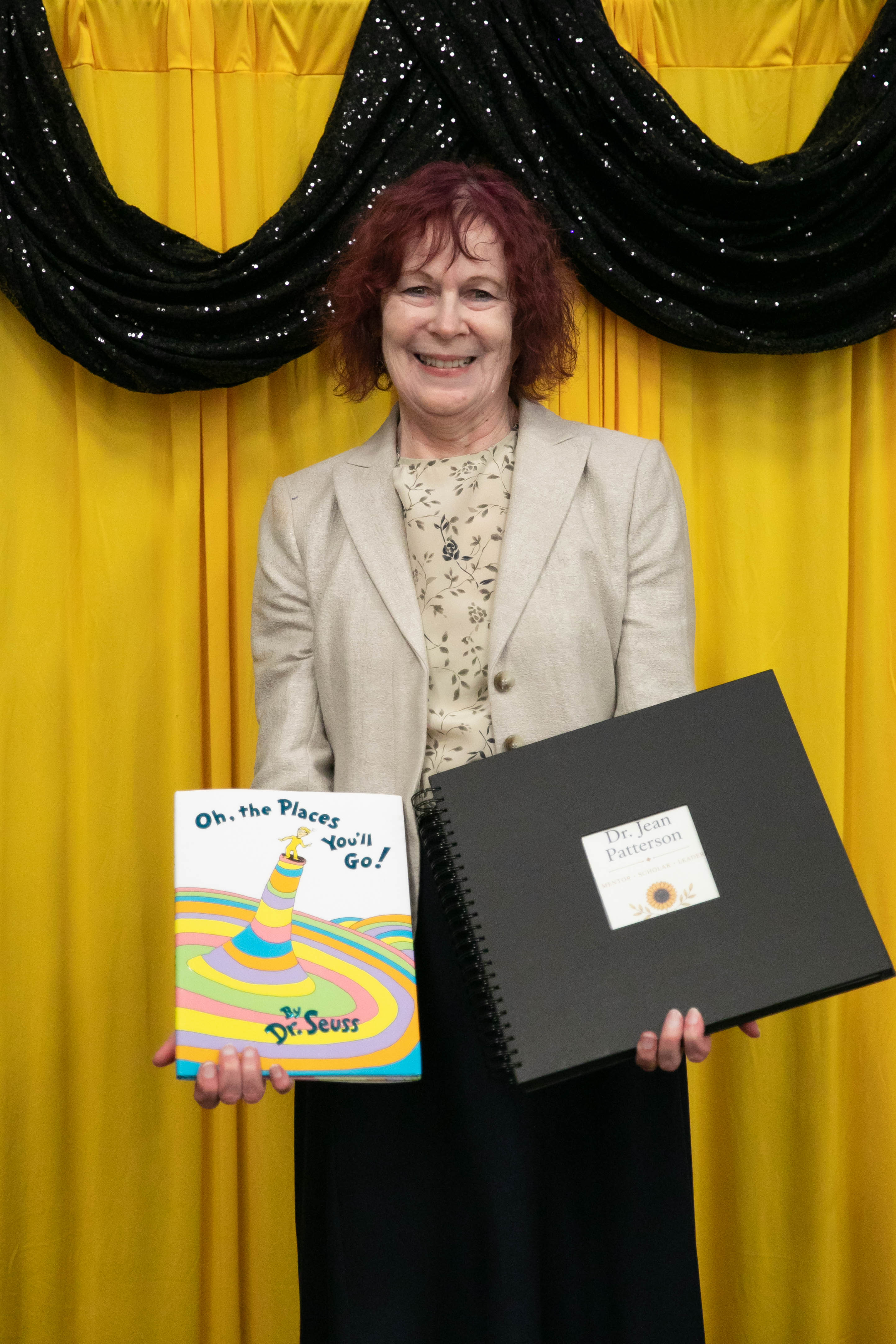 Dr. Jean Patterson poses with gifts and recognition items during the Wichita State University educational leadership EdD program spring 2026 luncheon.