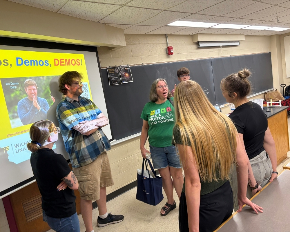 WSU science education students talk with a conference attendee following their “Demos, demos, DEMOS!” presentation at KATS Kamp.