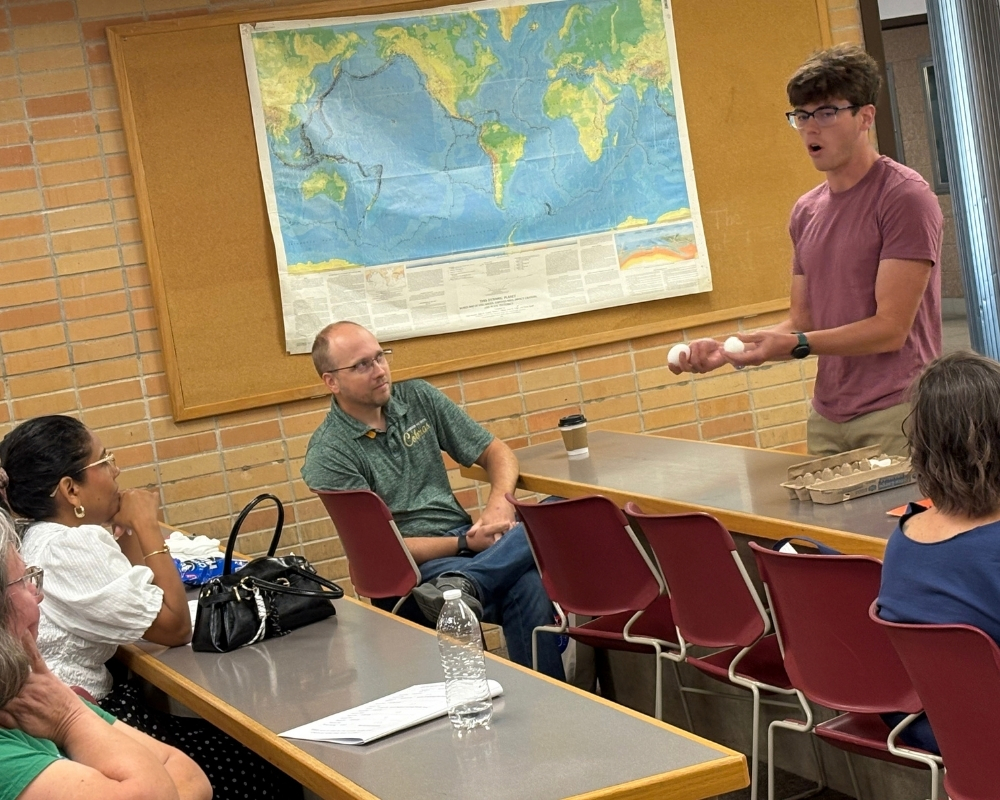 WSU science education student demonstrates a hands-on science activity using eggs for attendees during the KATS Kamp conference.