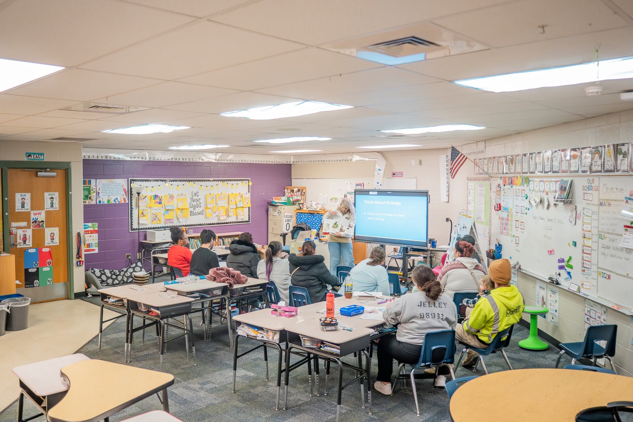 Educators, parents, and students gather for an activity during a CLEAR family literacy night event