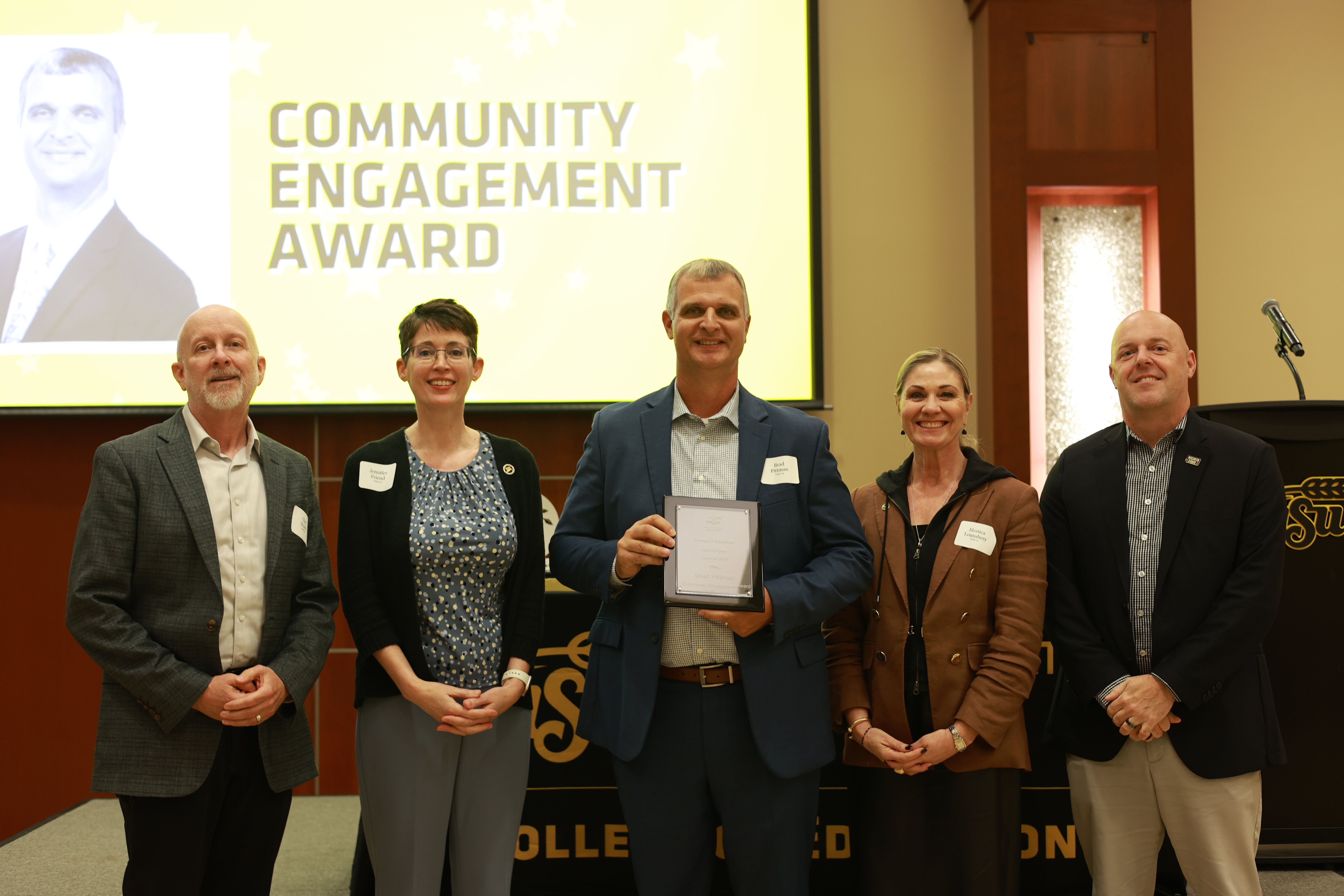 Clay Stoldt, professor in the College of Education; Jennifer Friend, dean of the College of Education; 2026 Hall of Fame inductee Brad Pittman; Monica Lounsbery, senior executive vice president and provost at Wichita State; and Telly McGaha, president and CEO of Wichita State University Foundation and Alumni Engagement, pose following Pittman’s recognition with the Community Engagement Award
