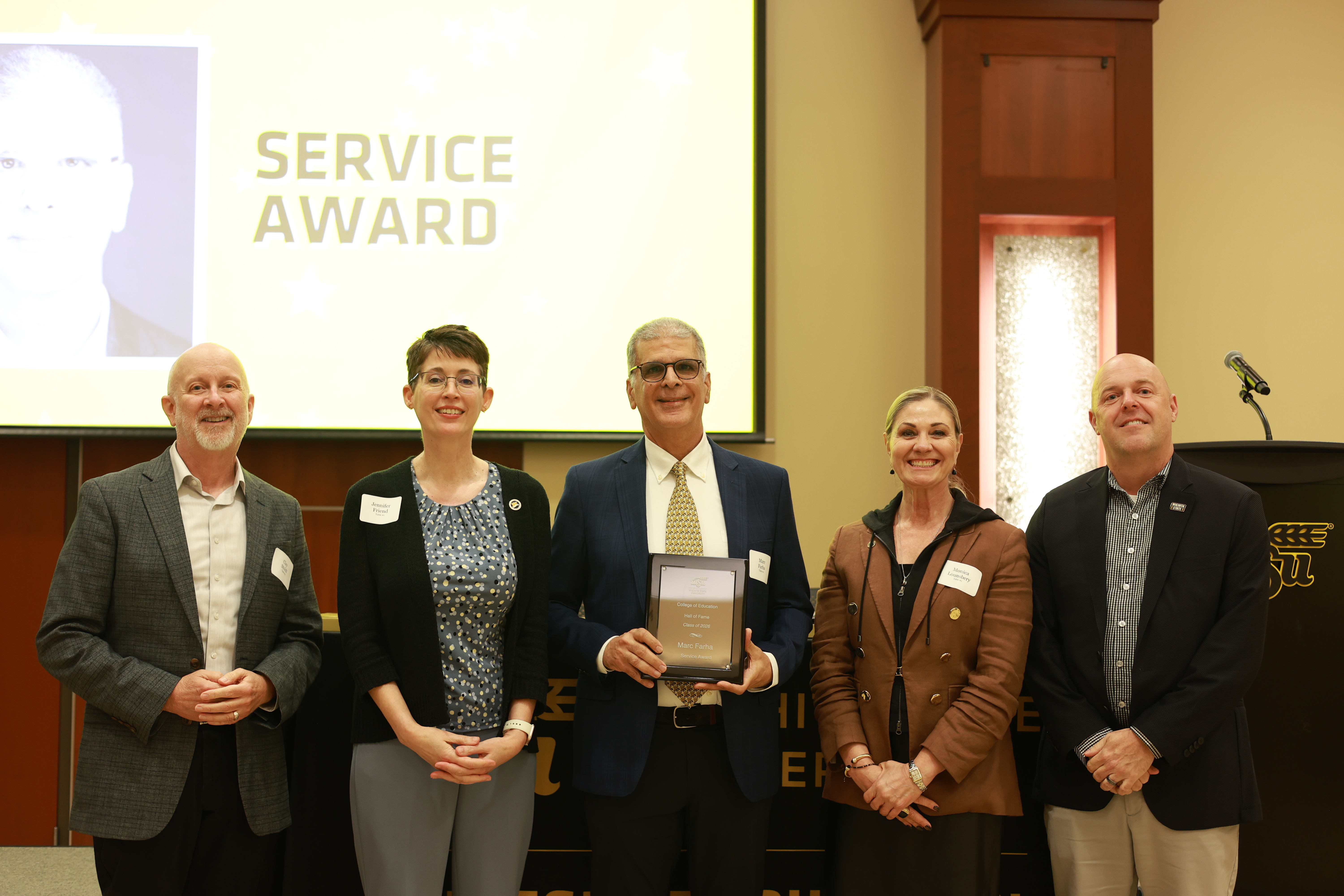 Marc Farha poses with College of Education and Wichita State leaders after receiving the Service Award at the 2026 Hall of Fame ceremony.