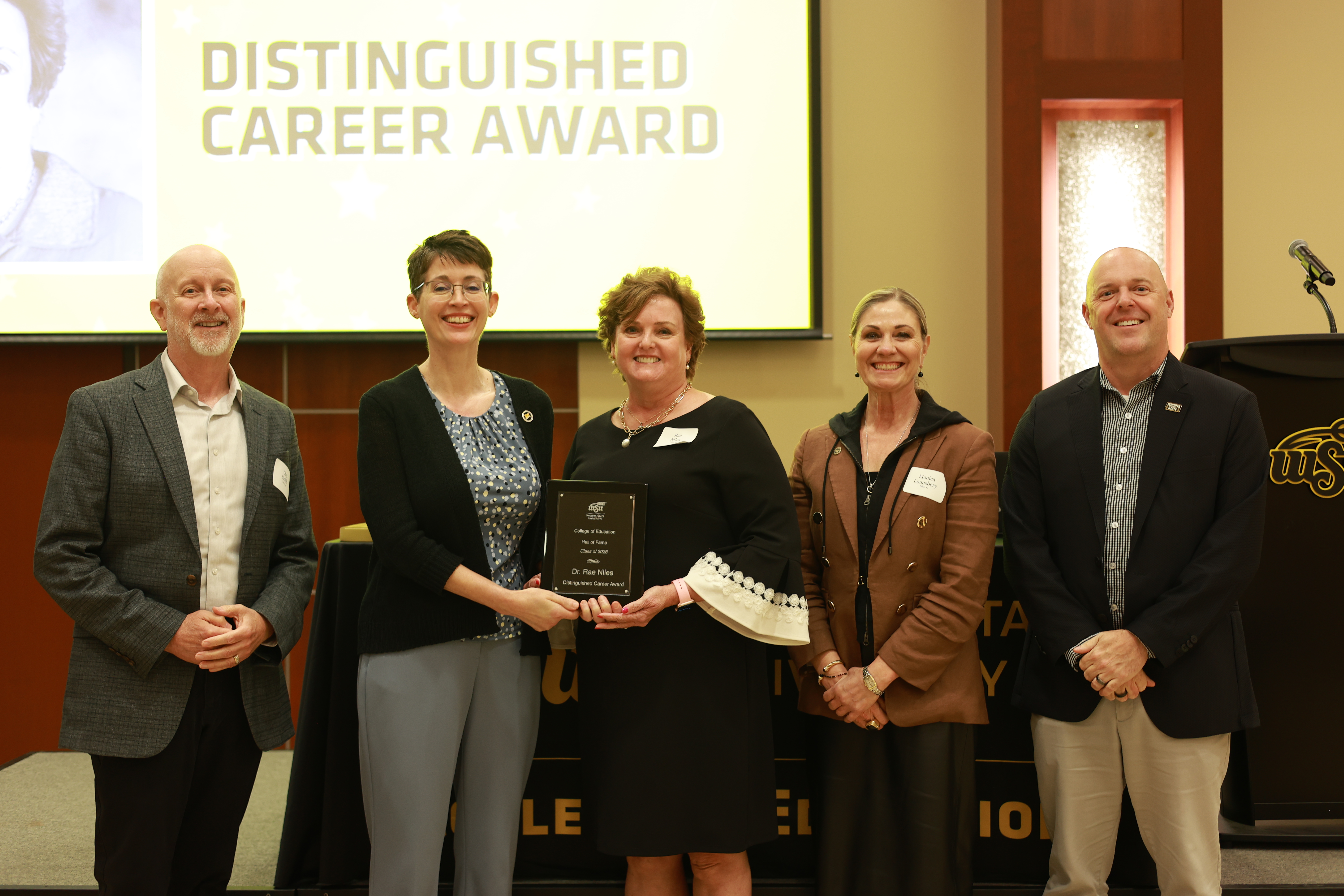 Dr. Rae Niles poses with College of Education and Wichita State leaders after receiving the Distinguished Career Award at the 2026 Hall of Fame ceremony.
