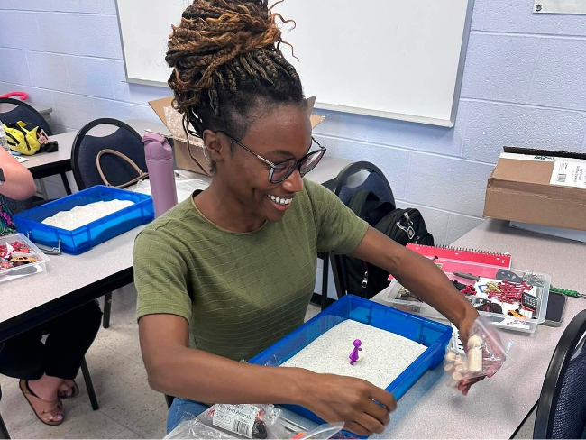 Counseling student, Brenda Mattson explores her sandtray kit provided by Project Teacher in CESP 750p, Counseling Children and Adolescents.