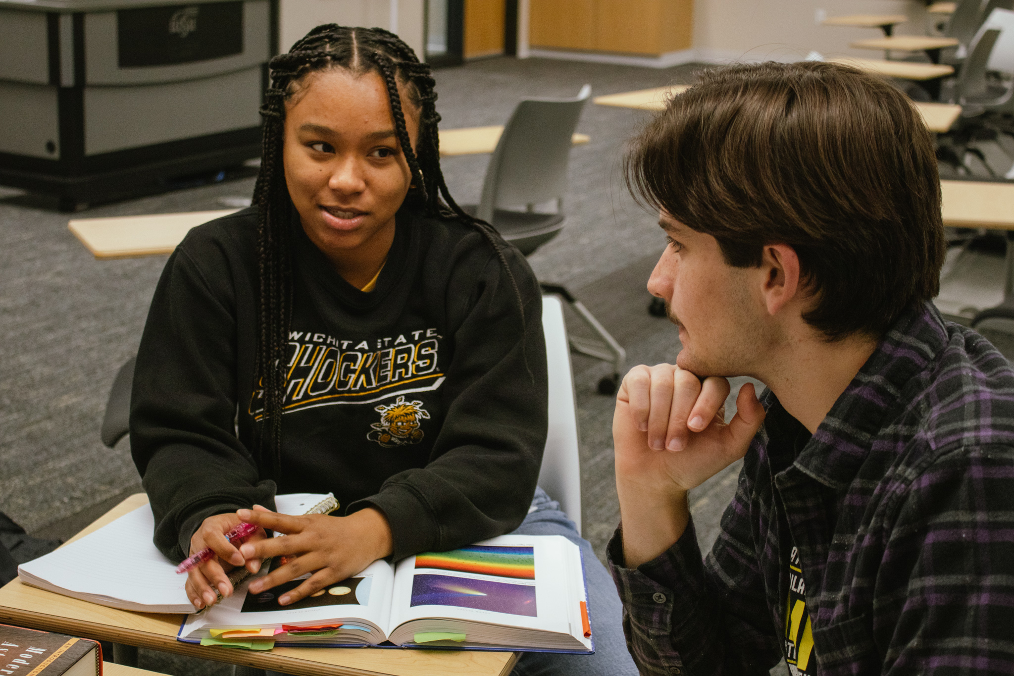 A student and teacher are having a discussion.