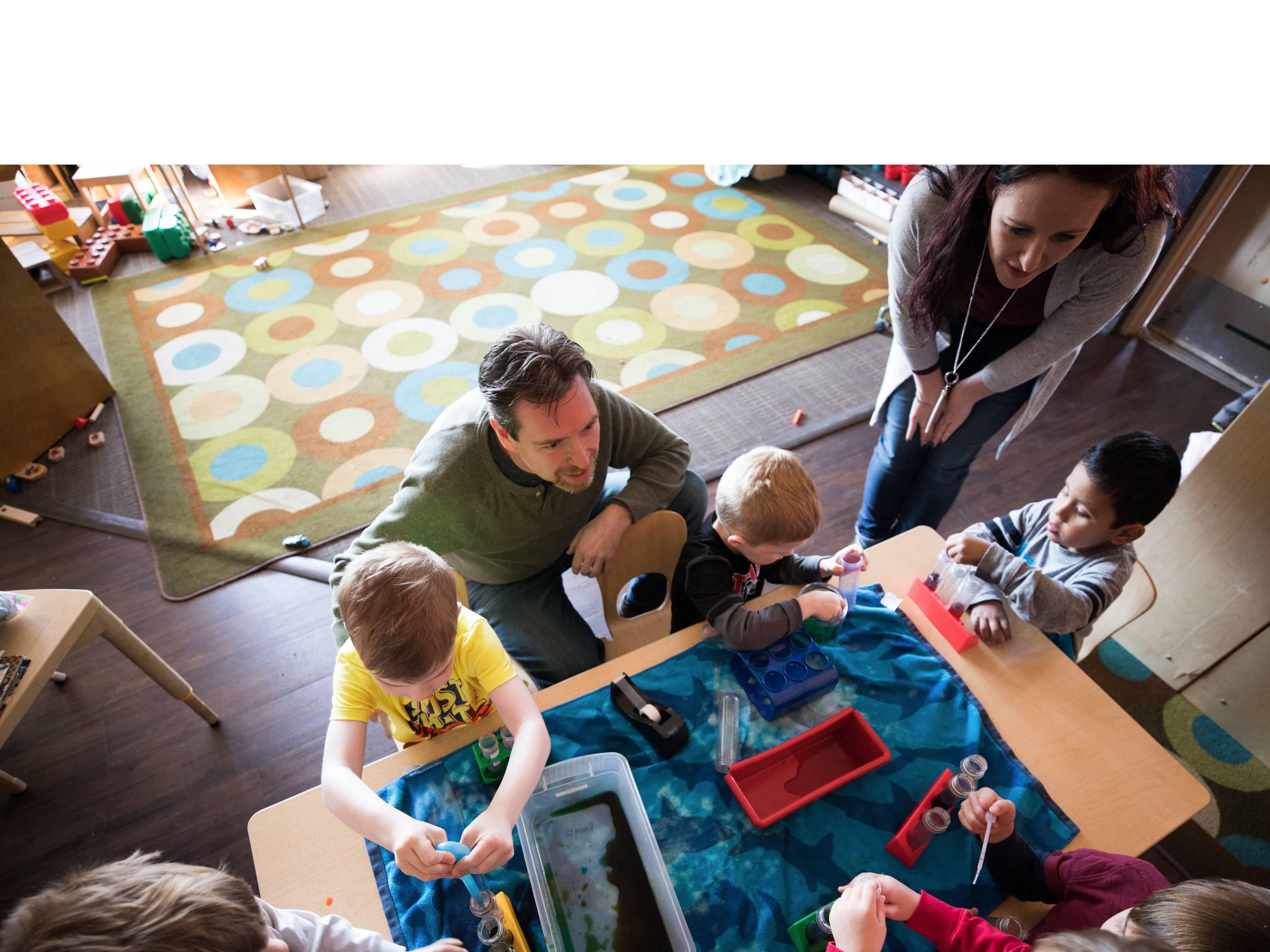 Photo of a member of the TAP program engaged in an activity with elementary school age children. 