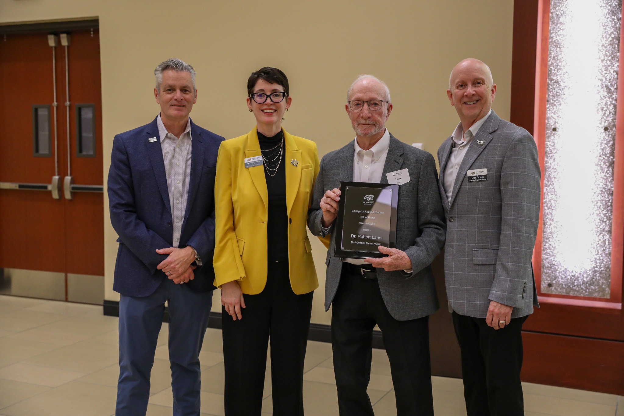 Dr. Robert Lane receives the Distinguished Career Award as part of his induction into the College of Applied Studies Hall of Fame during the 2025 Induction Ceremony in September. Pictured with him are WSU President Dr. Richard Muma, CAS Dean Dr. Jennifer Friend, and CAS Professor Dr. Clay Stoldt.