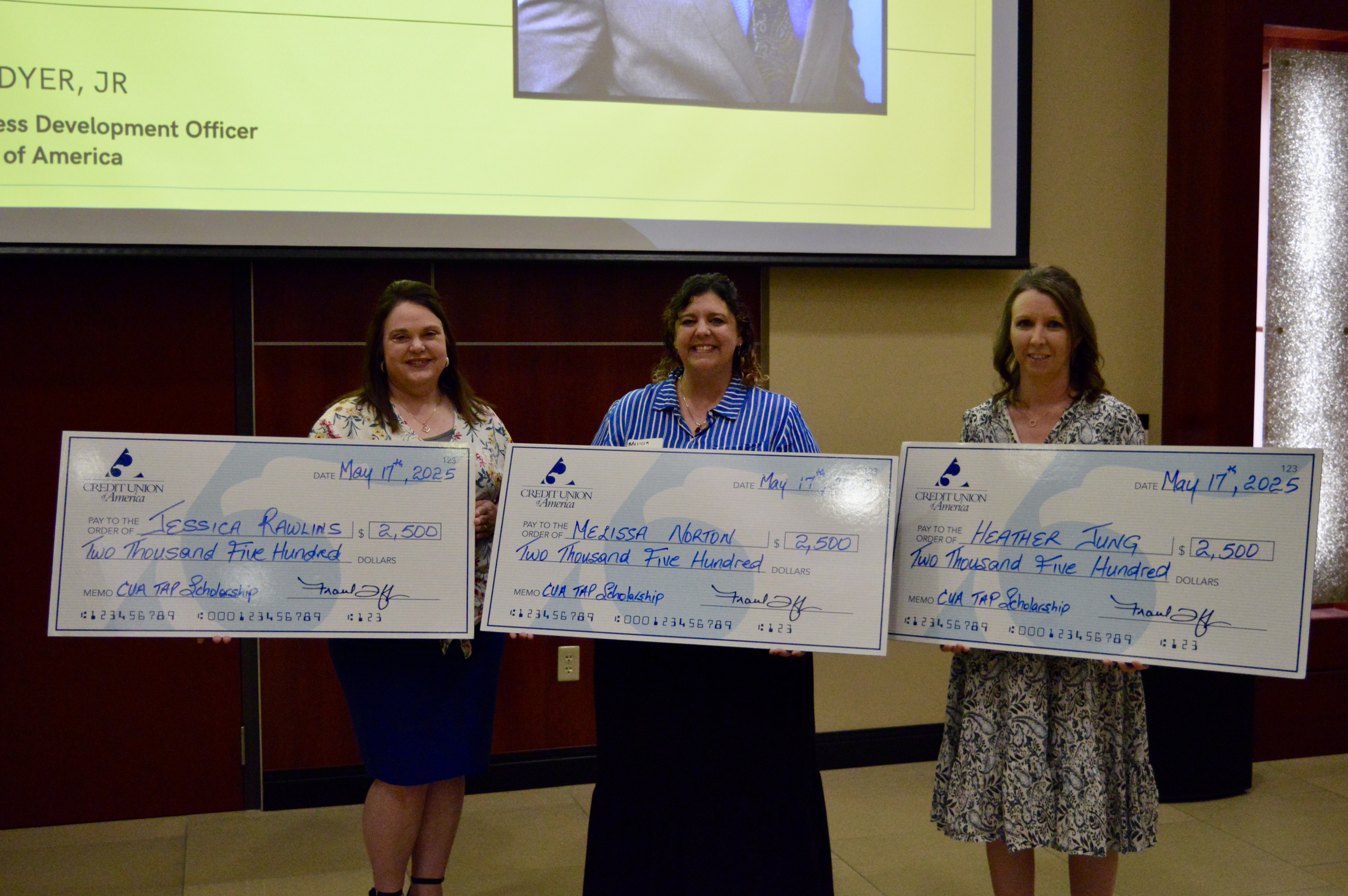 Scholarship winnners with big checks