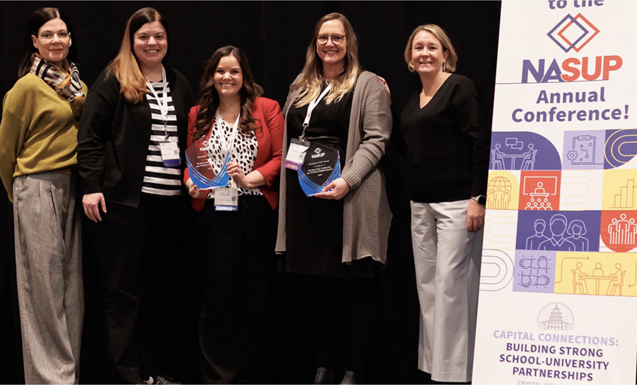 Representatives from Wichita State University and Wichita Public Schools attended the National Association for School-University Partnerships (NASUP) Annual Conference in Washington, D.C., where the institutions received the NASUP Exemplary School-University Partnership Award. Pictured (left to right): Stacy Chestnut, English teacher at East High School, Wichita Public Schools; Holly Ingram, assistant superintendent of learning services, Wichita Public Schools; Tammy Martin, executive coordinator of new teacher induction, Wichita Public Schools; and Heidi Stinchcomb, associate dean of the College of Education at Wichita State University.
