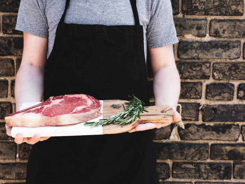 Hospitality Management thumbnail of restaurant employee holding a plate of food