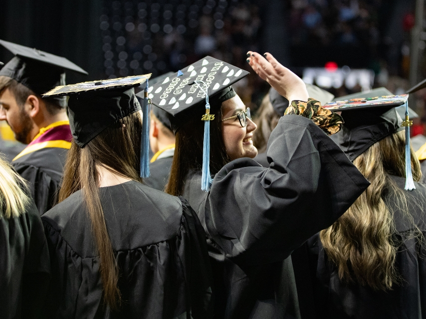 commencement ceremony wichita state unviersity, woman waving