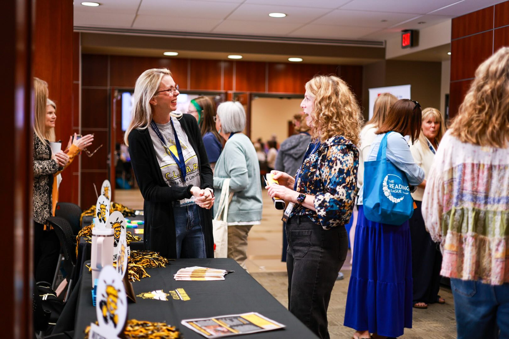 Dr. Kim Wilson of the College of Education speaking with an attendee at the 2026 Elevating Literacy Conference at Wichita State University