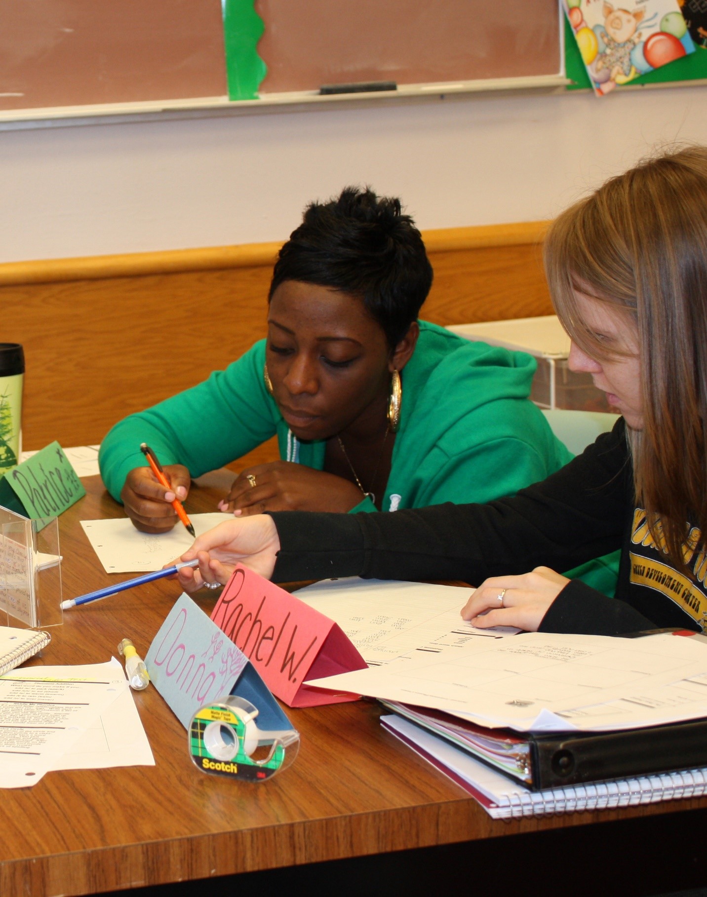 teacher assisting a student