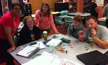 Five young teachers around a table