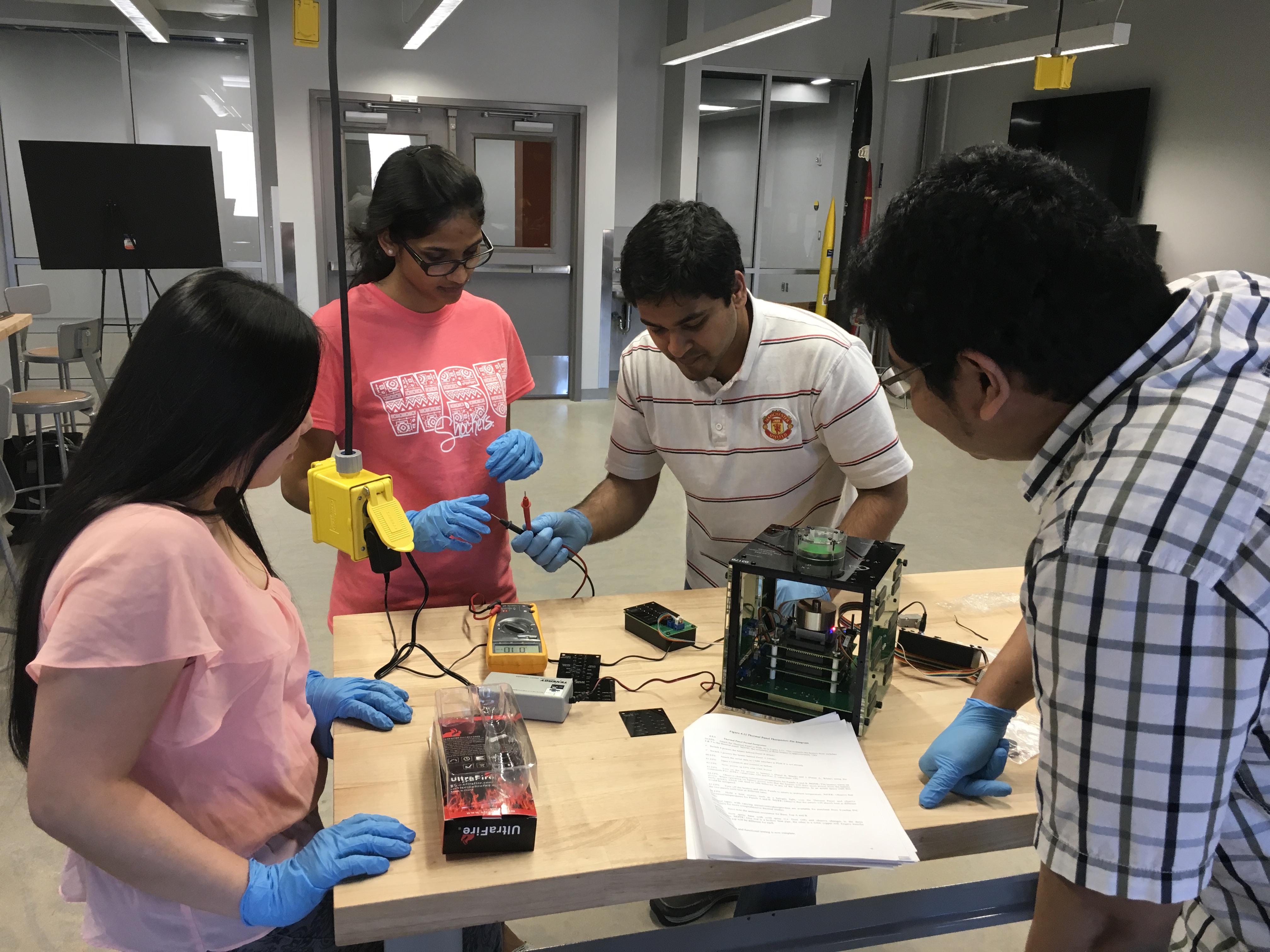 Students working on nanosatellites. 