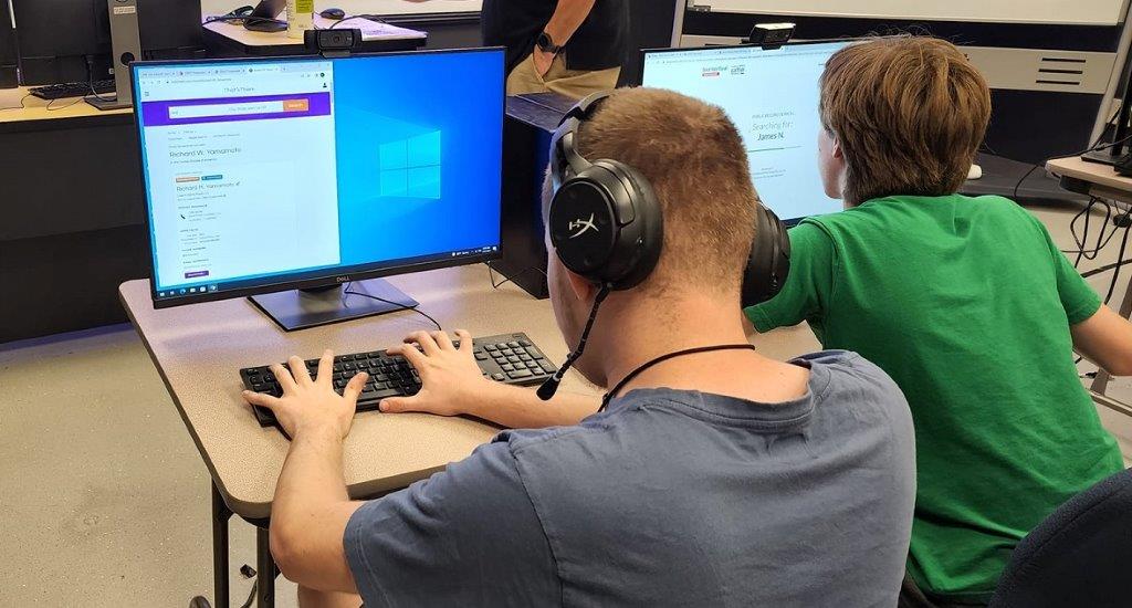 two students are learning how to code 