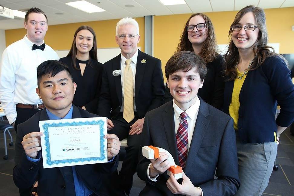 A team of students with their faculty mentors, all dressed up for the final competition.